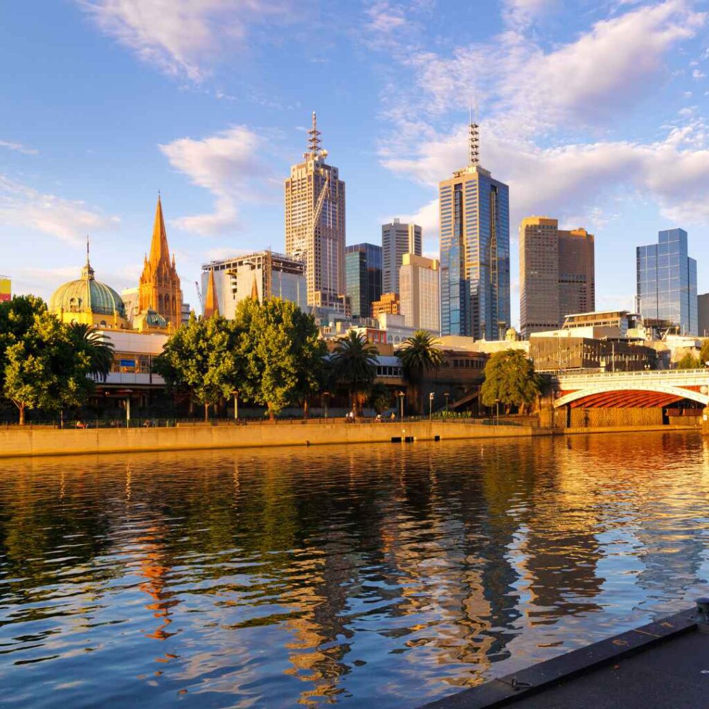 The skyline of Melbourne and the Princess Bridge at dusk.