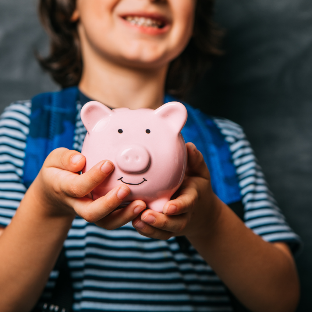 boy holding a piggie bank