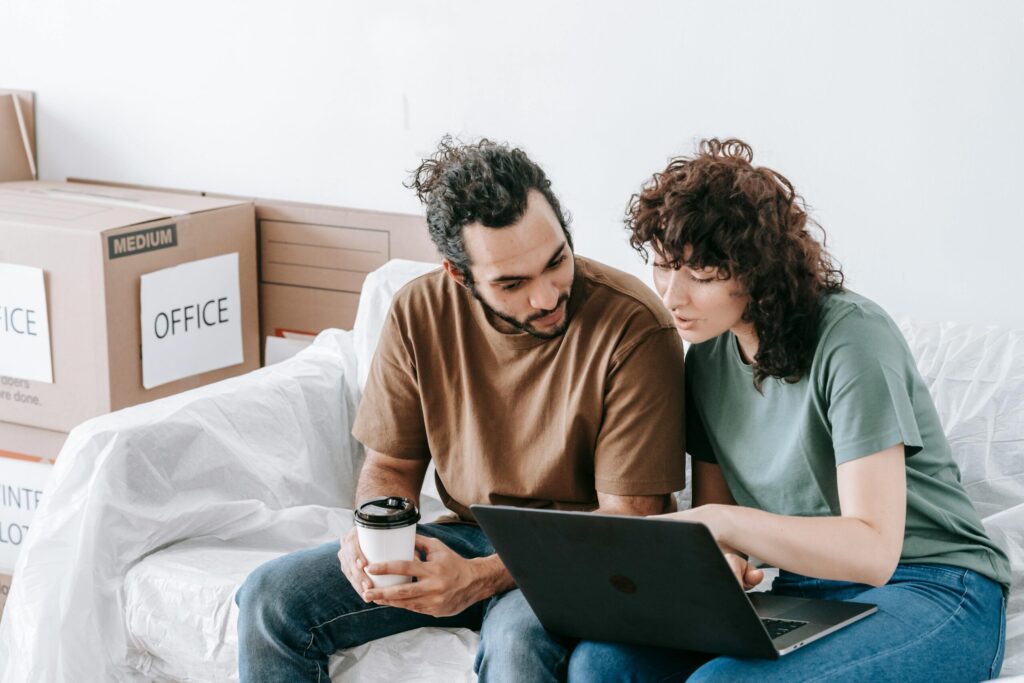 Couple looking at computer booking their move with Santa Fe Relocation. It was so simple and easy, and they know they are in safe hands with one of the top moving company in Singapore.