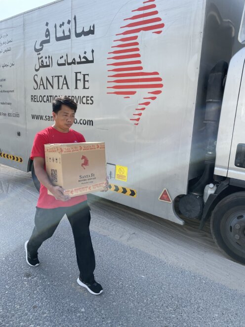 One of the Santa Fe team with the Santa Fe Moving van, ready to go and help another family moving internationally.