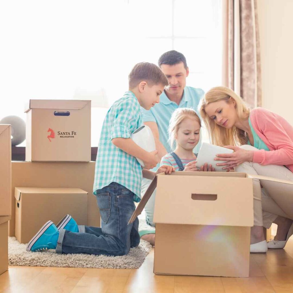 Family opening new boxes at their new house. All achievable with Santa Fe Relocation.